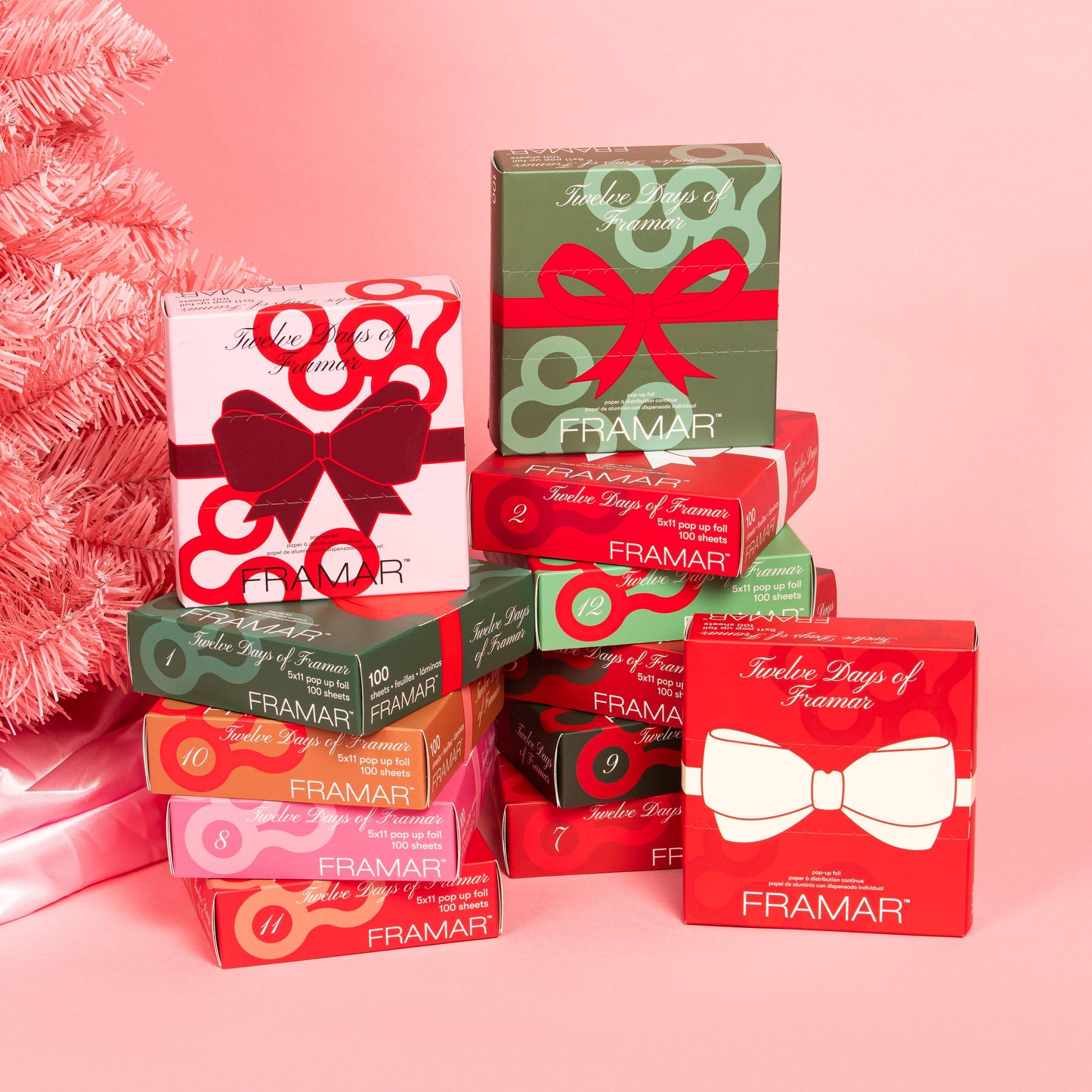 Stack of Framar product boxes with decorative bows on a pink background