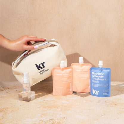 KR skincare products including a bag, bottles, and packets on a beige surface.