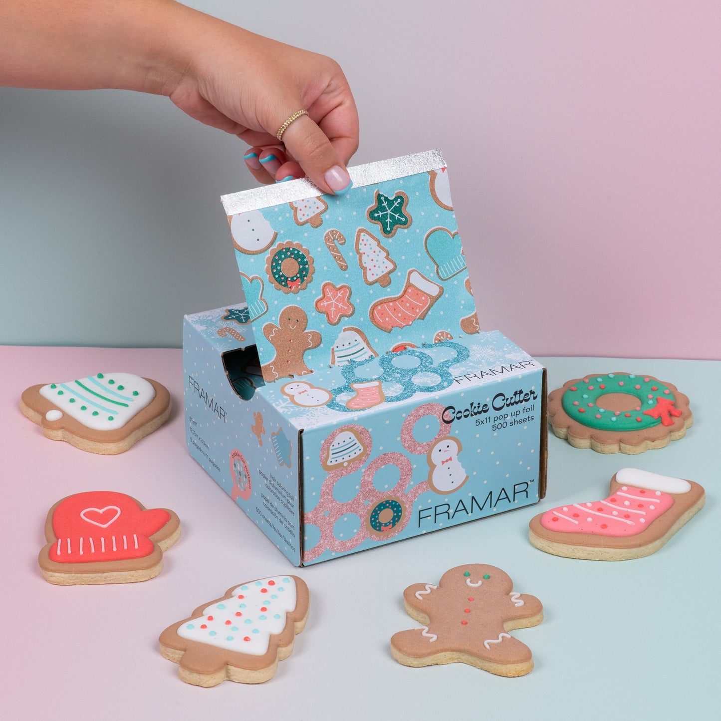 Framar cookie cutter set with decorative cookies on a light pink surface