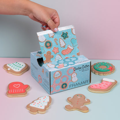 Framar cookie cutter set with decorative cookies on a light pink surface