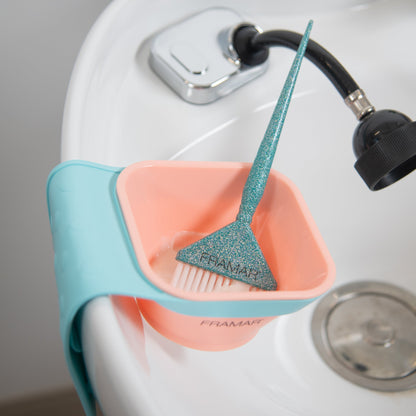 Pet grooming tool with a pink basin and blue handle attached to a sink.