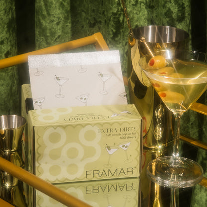 Box of Framar Extra Dirty tissues with a cocktail and bar tools on a green background